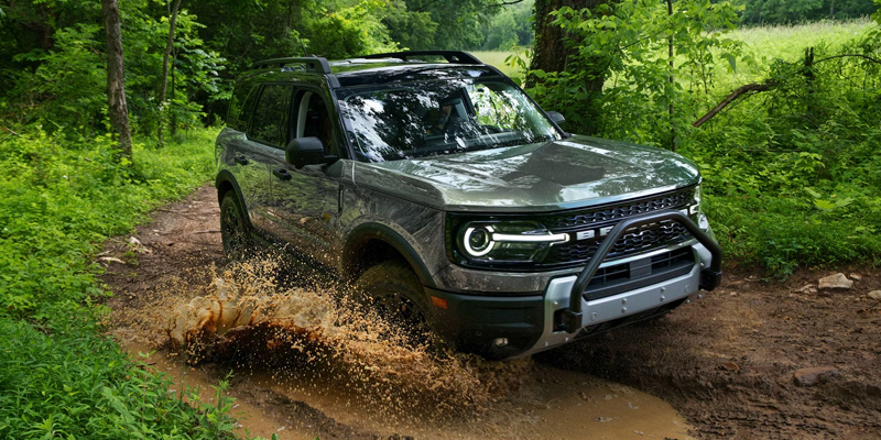 Ford Bronco Sport navigating a muddy trail with off-road prowess.