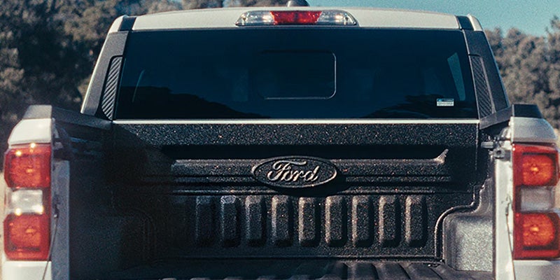 Rear view of a Ford pickup truck with a bed cover.